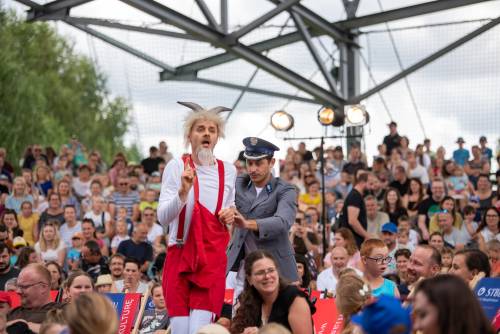 Koziołek Matołek i policjant wśród publiczności.